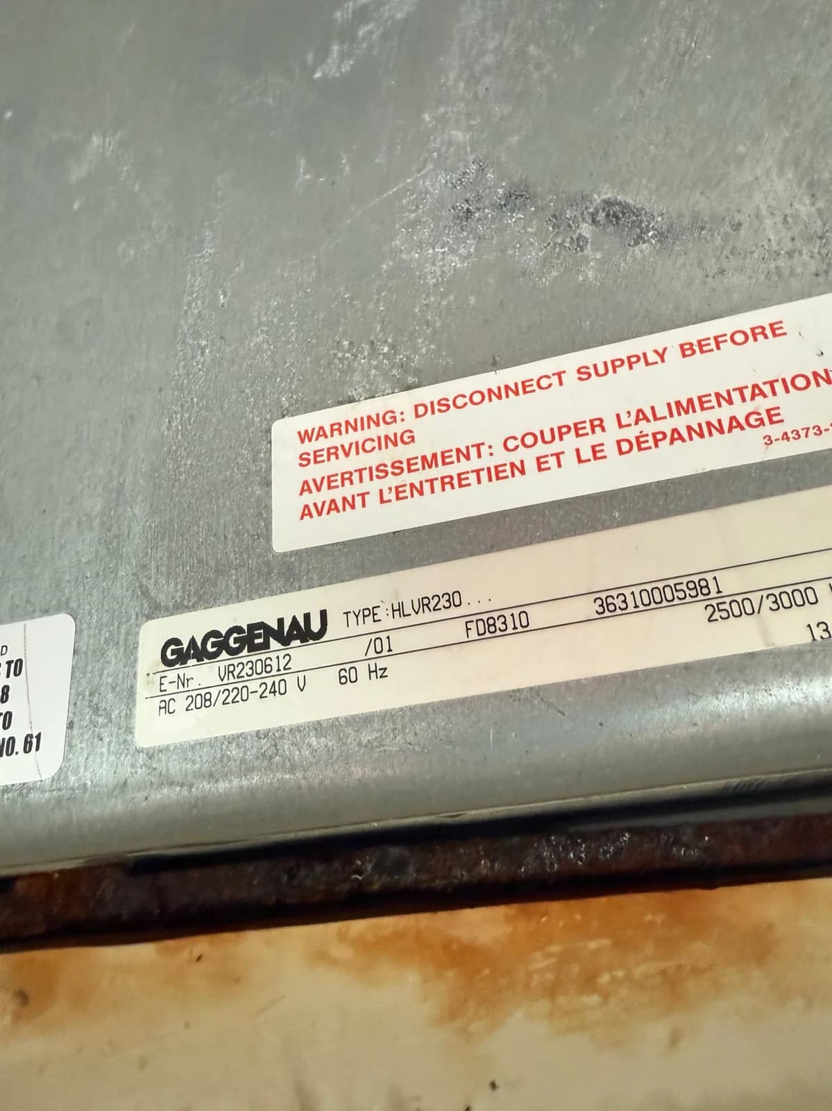 An appliance's information sticker, showing 'GAGGENAU' and 'TYPE HLV R230'