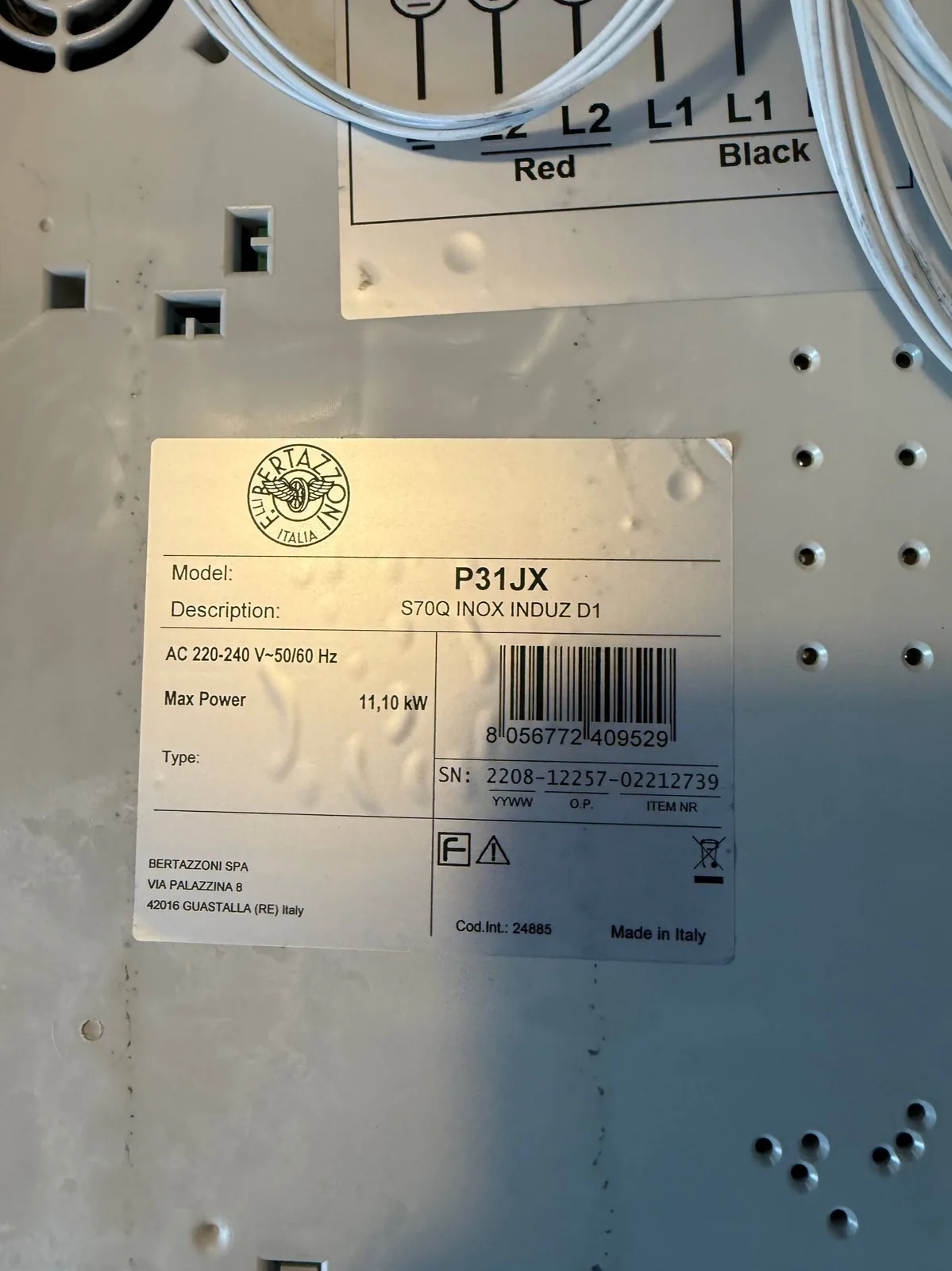 A close-up of a Bertazzoni cooktop repair label, showing the model number P31JX and other technical specifications
