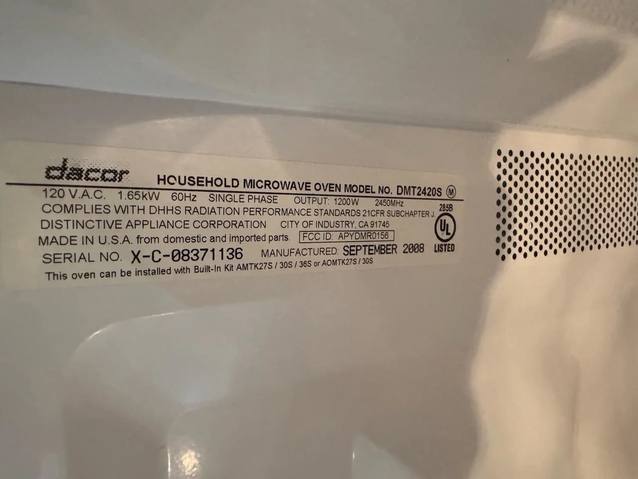 The label on the back of a Dacor household microwave oven shows the model number and serial number