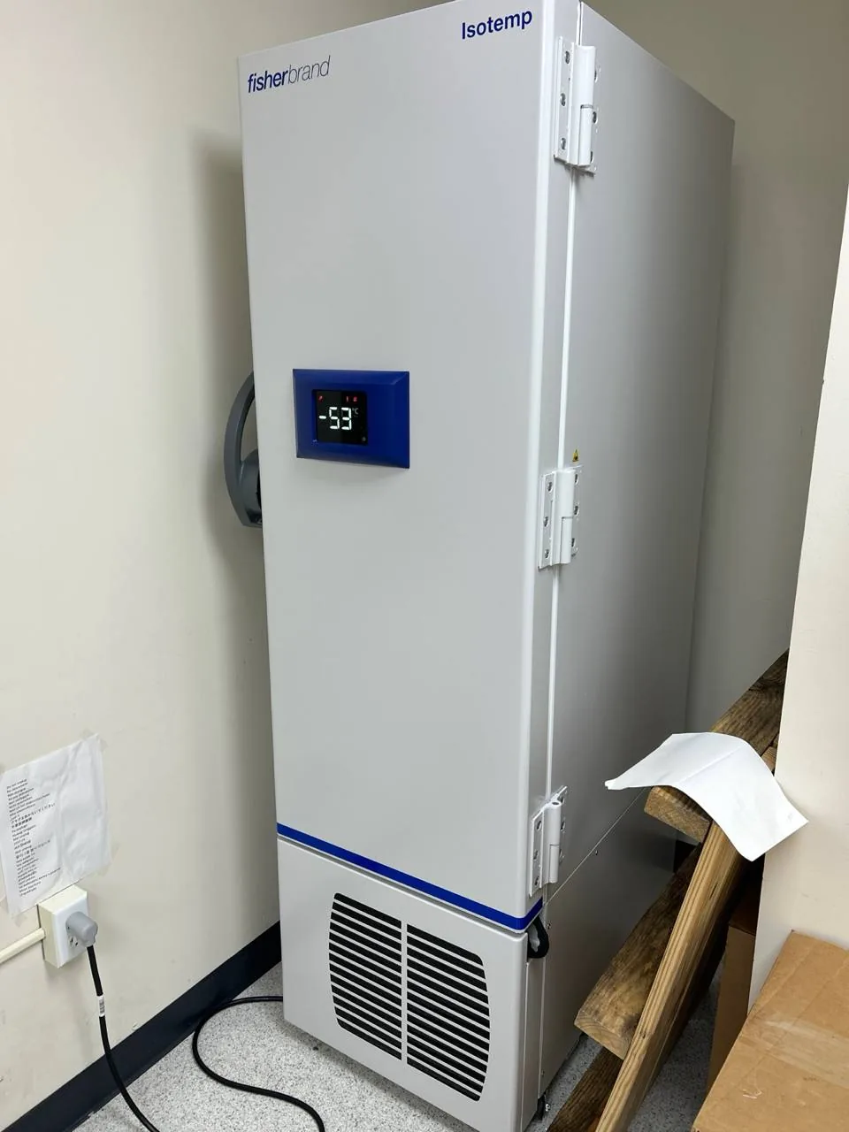 A white Fisher & Paykel Isotemp freezer in a room with a digital display showing -53 degrees