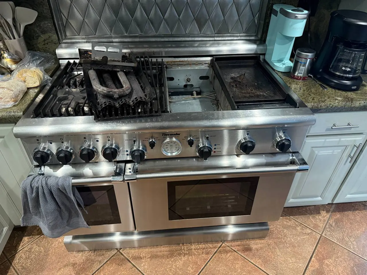 A Thermador professional range with a griddle, appearing to be in need of repair