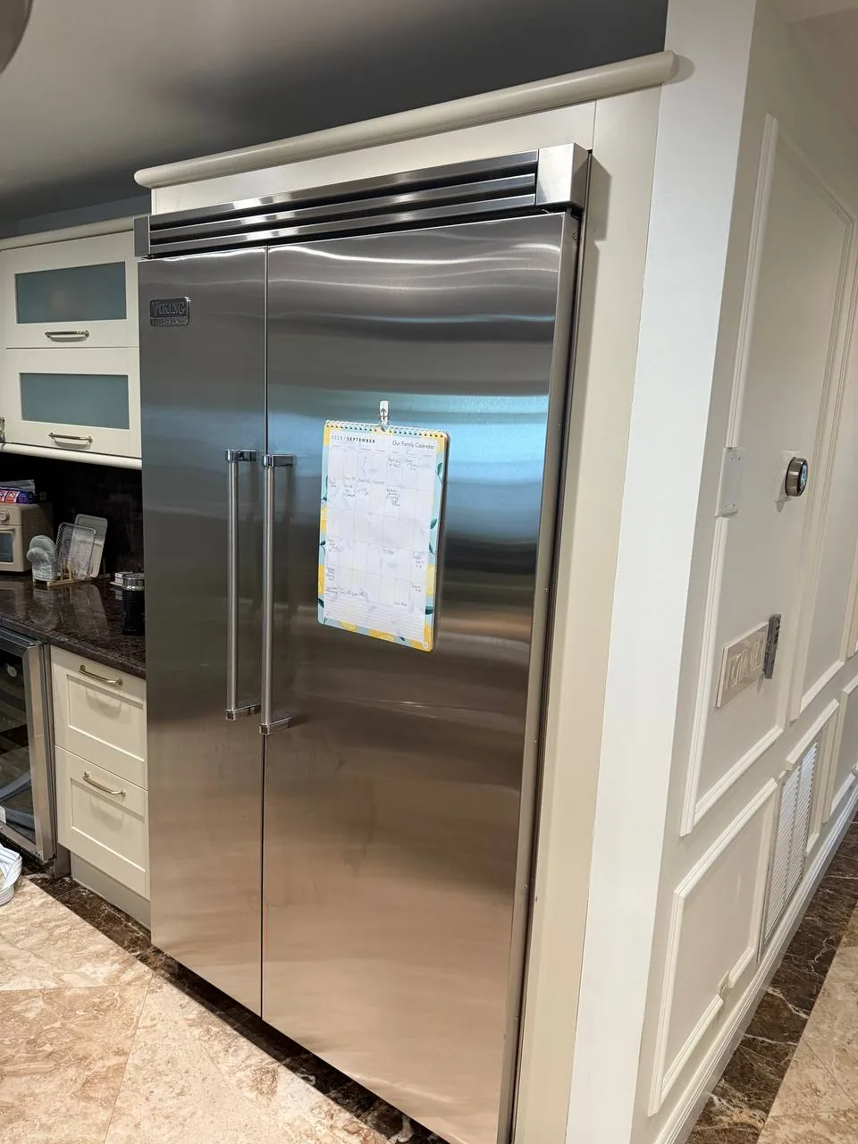 A stainless steel Viking refrigerator in a kitchen setting