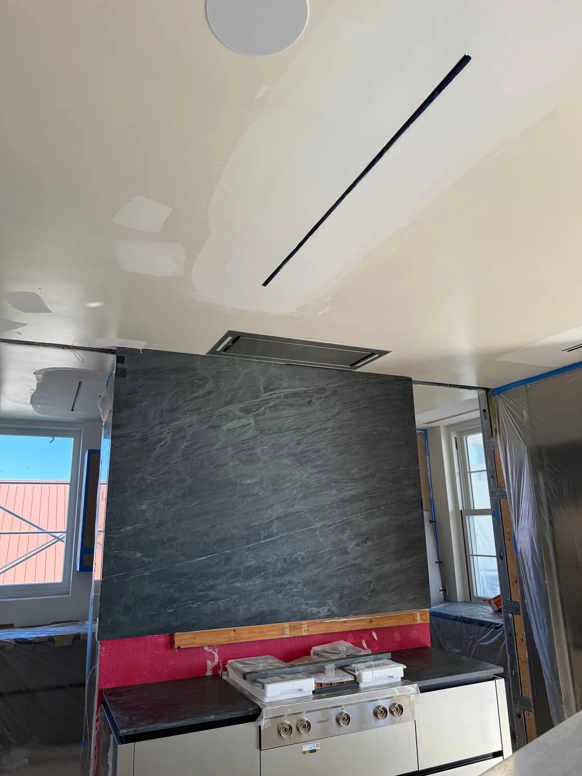 A new Wolf cooktop is installed in a kitchen under renovation