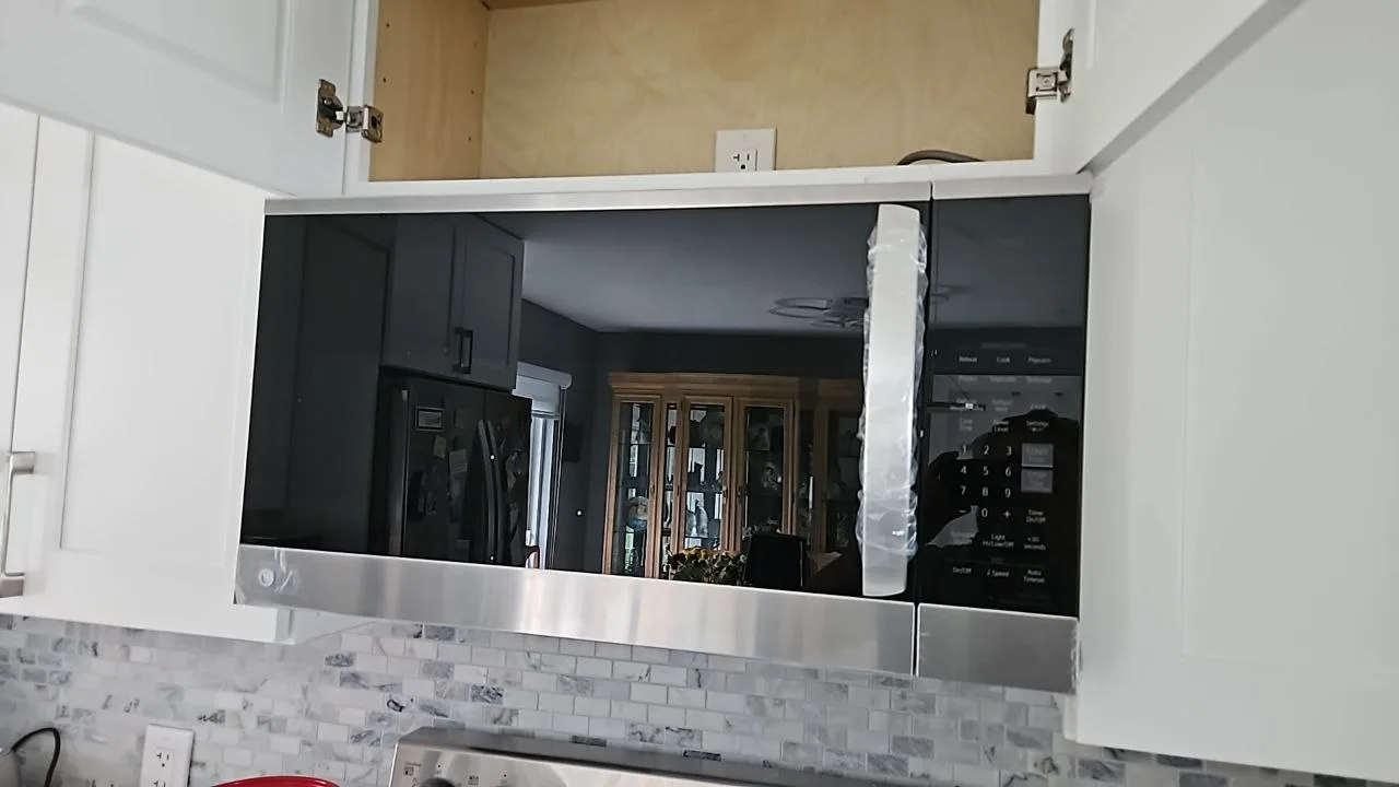 Berne technician repairing a microwave in South Florida